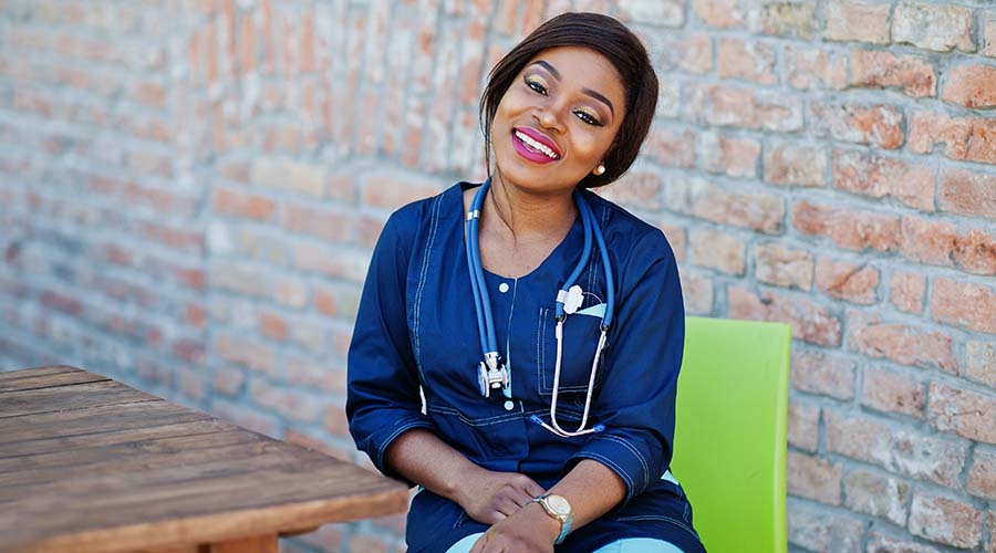 african-caregiver-female-with-stethoscope-posed-outdoor.