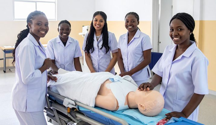A-group-of-young-African-nursing-assistant-students-in-crisp-white-uniforms-attending-a-practical-session. CNA Training Colleges in Nairobi.